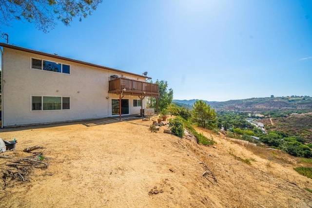 back of house with a mountain view
