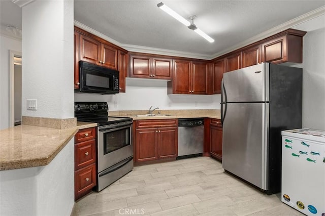 kitchen featuring sink, light stone counters, ornamental molding, kitchen peninsula, and stainless steel appliances