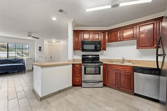 kitchen featuring sink, kitchen peninsula, ceiling fan, stainless steel appliances, and light stone countertops