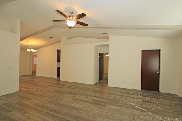 spare room with dark hardwood / wood-style flooring, ceiling fan with notable chandelier, and vaulted ceiling