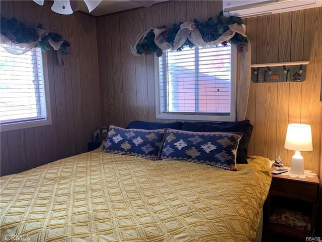 bedroom with an AC wall unit and wooden walls