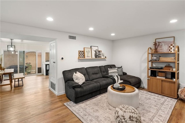 living room featuring visible vents, recessed lighting, and light wood-type flooring