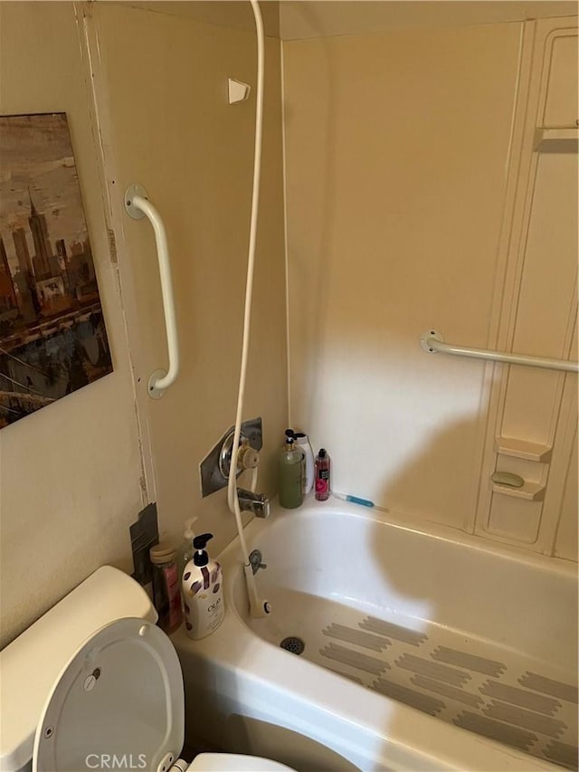 bathroom with toilet and bathtub / shower combination