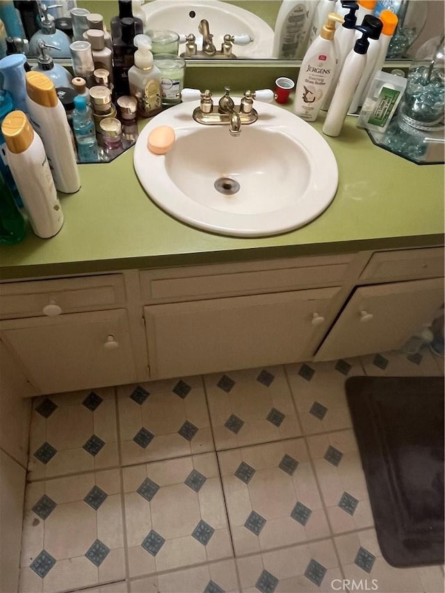 bathroom with tile patterned floors and vanity