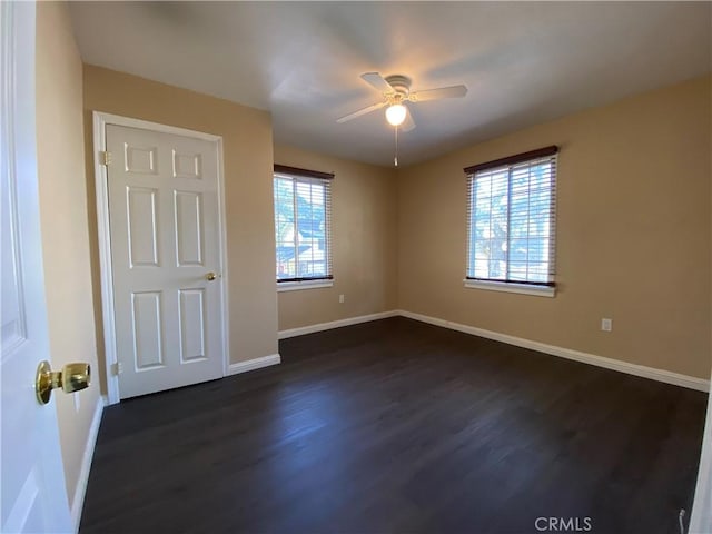 unfurnished room featuring dark hardwood / wood-style flooring and ceiling fan