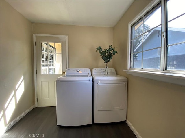 clothes washing area with dark hardwood / wood-style floors and independent washer and dryer