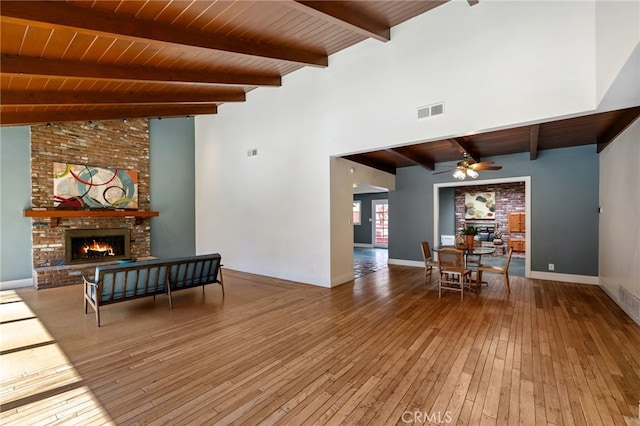 living room with a fireplace, wooden ceiling, ceiling fan, and wood-type flooring