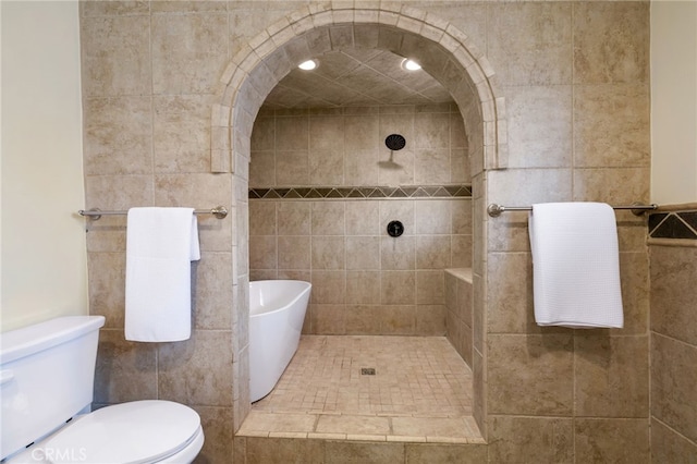 bathroom featuring toilet and a tile shower