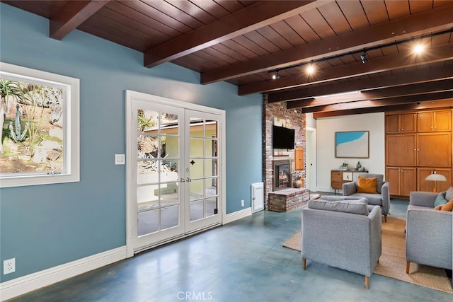 sitting room featuring french doors, beamed ceiling, wooden ceiling, and a fireplace