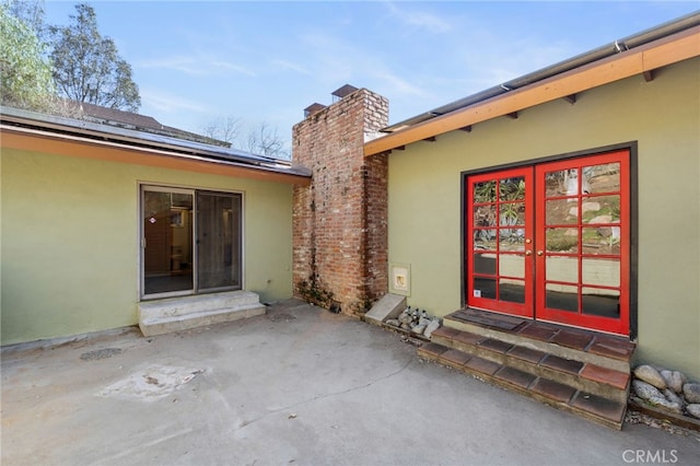 entrance to property featuring a patio and french doors