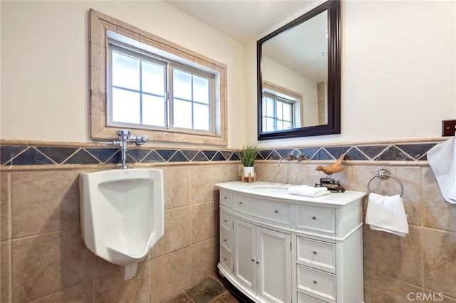 bathroom with tile walls and vanity