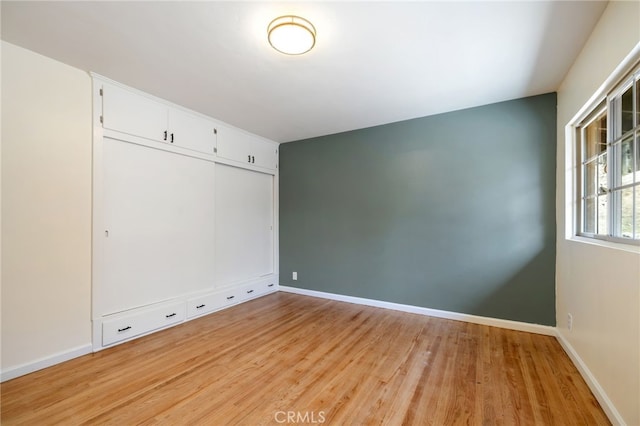 spare room with light wood-type flooring