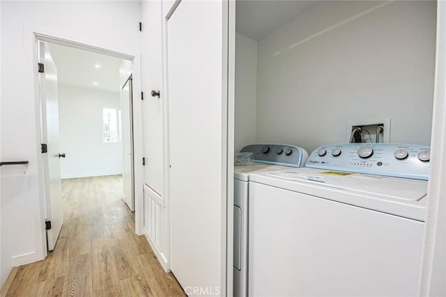 laundry room featuring light hardwood / wood-style floors and independent washer and dryer