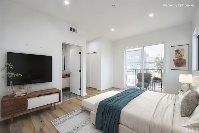 bedroom with wood-type flooring, access to exterior, and connected bathroom