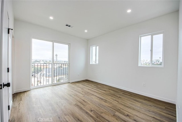 spare room with hardwood / wood-style floors