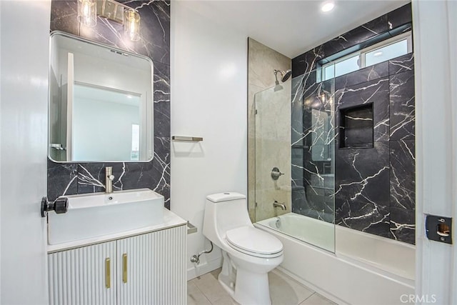 full bathroom with tiled shower / bath combo, vanity, tile patterned floors, and toilet