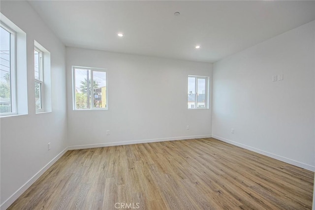 unfurnished room with light hardwood / wood-style floors