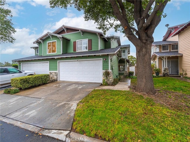 view of front of home with a garage and a front lawn