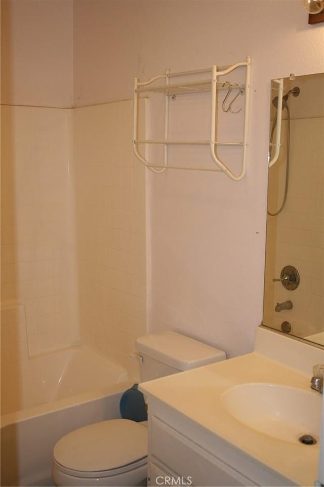 full bathroom featuring washtub / shower combination, vanity, and toilet