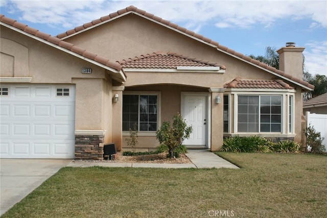 view of front of property with a garage and a front yard