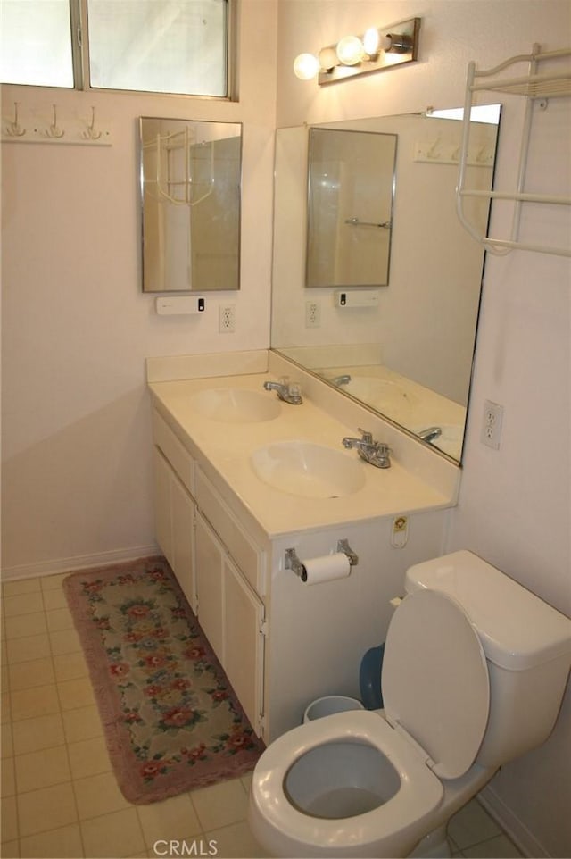 bathroom with tile patterned flooring, vanity, and toilet