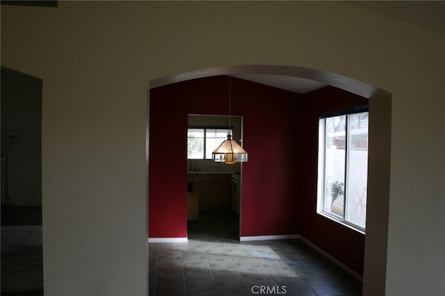 unfurnished room featuring lofted ceiling and sink