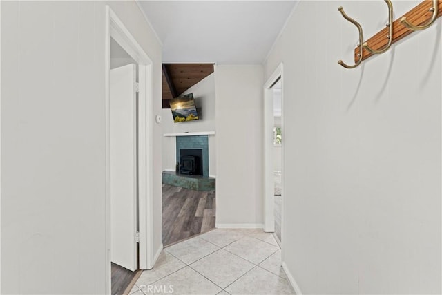 corridor with baseboards and light tile patterned floors