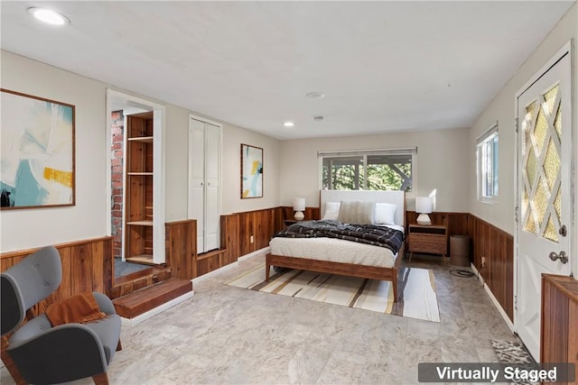 bedroom featuring recessed lighting, wainscoting, and wood walls