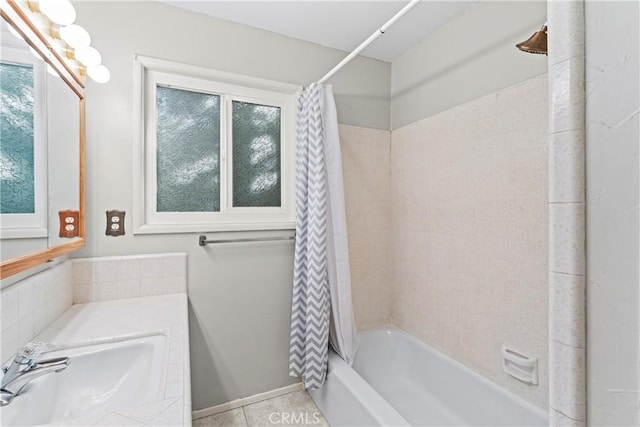 bathroom featuring plenty of natural light, shower / bath combo, a sink, and tile patterned floors