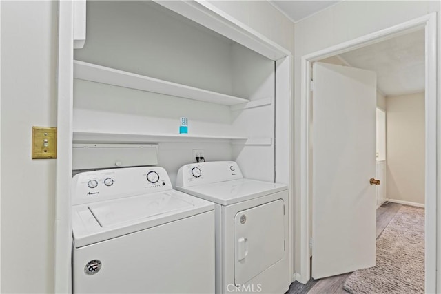 laundry area with light wood-type flooring, laundry area, and independent washer and dryer