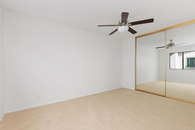 unfurnished bedroom with carpet floors, a closet, and ceiling fan