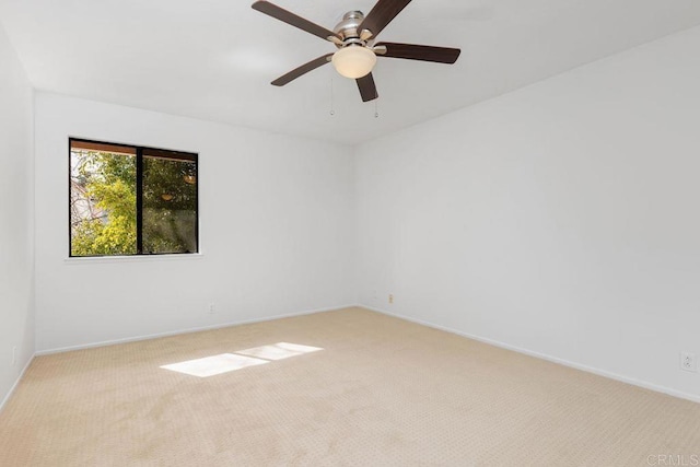 unfurnished room featuring light colored carpet and ceiling fan