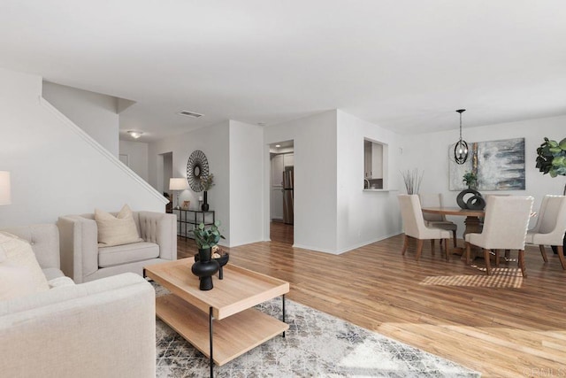 living room featuring light hardwood / wood-style flooring and a chandelier