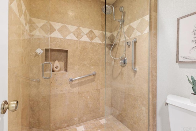 bathroom with an enclosed shower and toilet