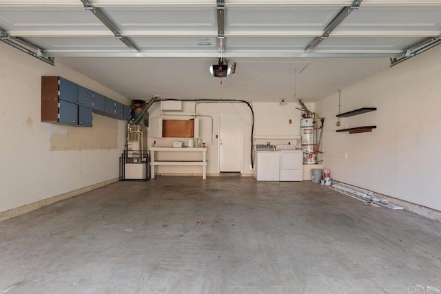 garage with a garage door opener, washer and clothes dryer, and strapped water heater