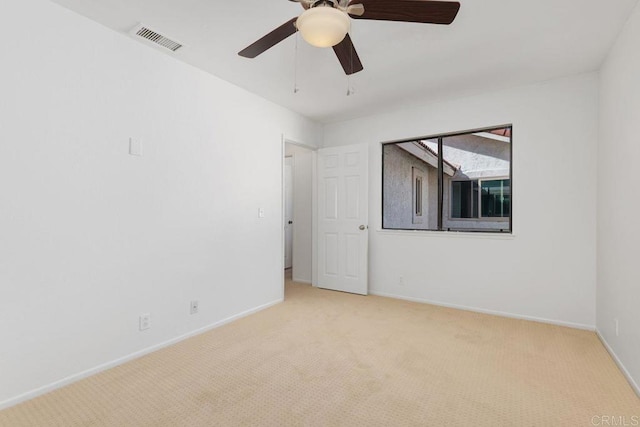 spare room with light carpet and ceiling fan