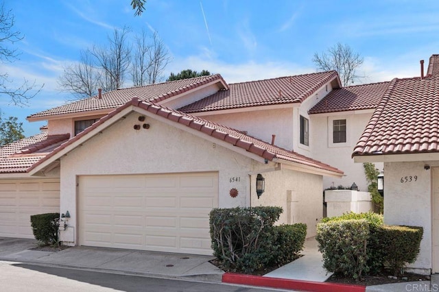 mediterranean / spanish-style home featuring a garage