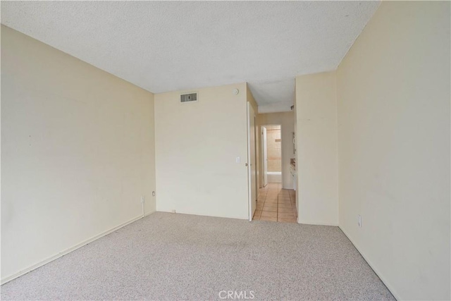 23515 Lyons Ave Unit 228, Valencia, CA 91355 - empty room with carpet floors and a textured ceiling