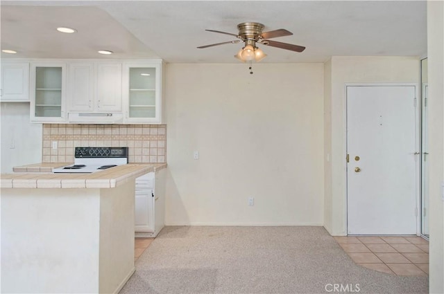 23515 Lyons Ave Unit 228, Valencia, CA 91355 - kitchen featuring white stove, tile counters, under cabinet range hood, white cabinetry, and recessed lighting