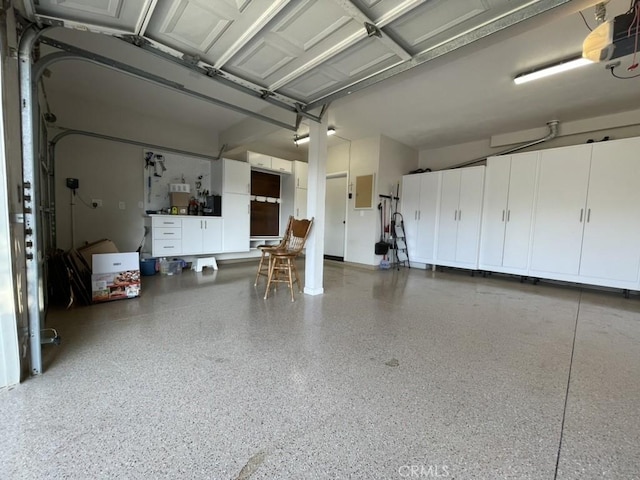 garage featuring electric panel and a garage door opener