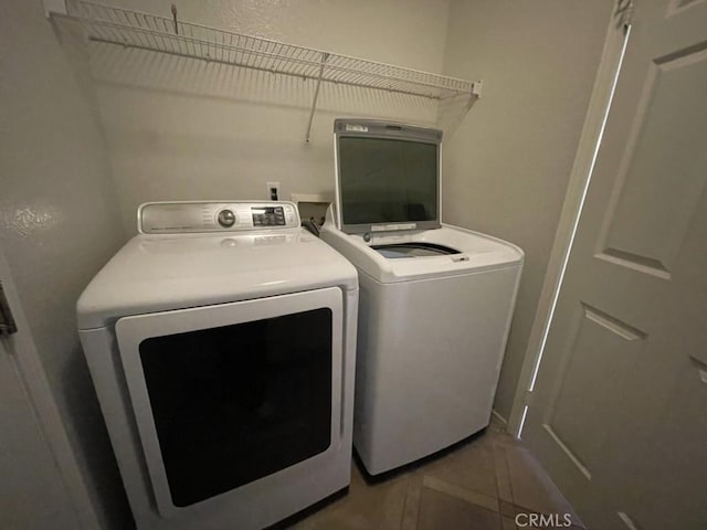 washroom with laundry area, tile patterned flooring, and washing machine and clothes dryer