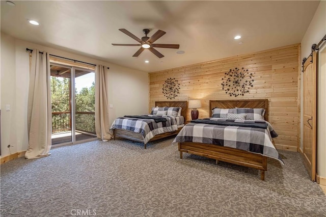 43625 Wolf Rd, Big Bear Lake, CA 92315 - carpeted bedroom with ceiling fan, wooden walls, a barn door, and access to exterior