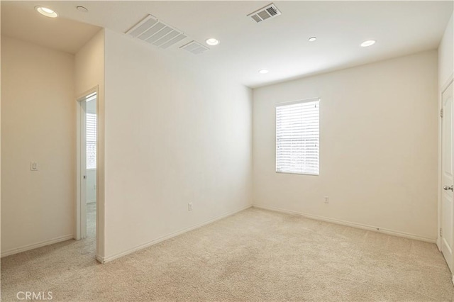 unfurnished room with light colored carpet