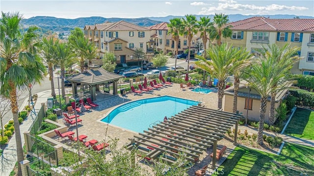 view of swimming pool with a pergola, a mountain view, a gazebo, and a patio area