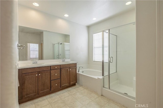 22059 Barrington Way, Saugus, CA 91350 - full bath with healthy amount of natural light, a garden tub, a stall shower, double vanity, and recessed lighting