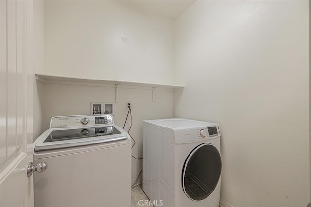 clothes washing area with separate washer and dryer