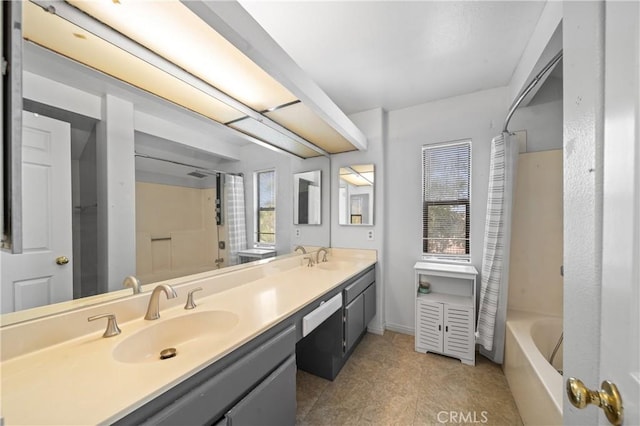 bathroom with vanity, a healthy amount of sunlight, and shower / bath combination with curtain