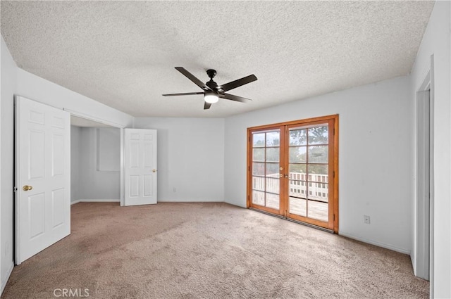 unfurnished bedroom with carpet, access to exterior, ceiling fan, a textured ceiling, and french doors