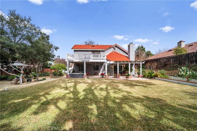 back of property featuring a yard, a pergola, and a patio area