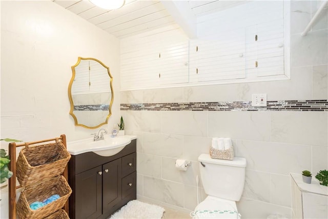 579 E Victoria Ct, Lake Arrowhead, CA 92352 - half bathroom with tile walls, vanity, and toilet